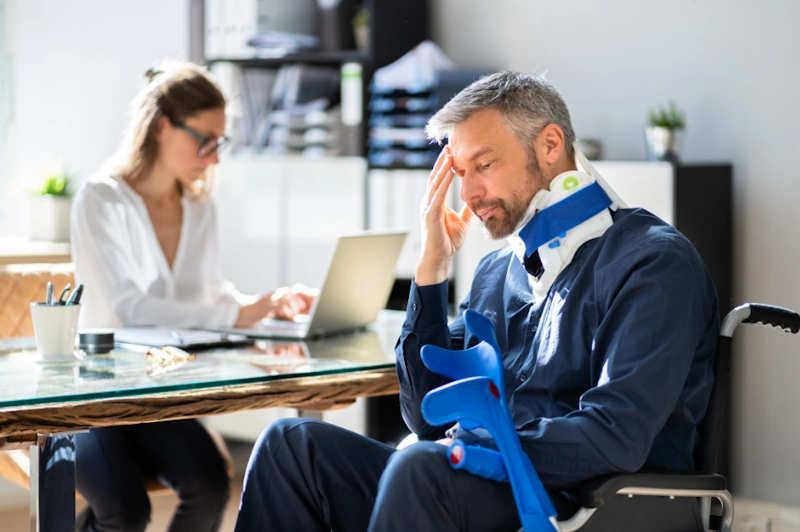 a person with a neck brace sitting in an office